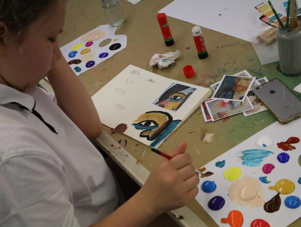 Das Bild zeigt ein Kind beim Malen.